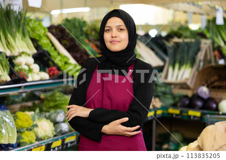 Young woman seller in hijab posing in grocery store 113835205