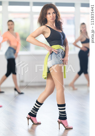 Adult woman dancing high heels in group Adult woman dancing high heels in group 113835441