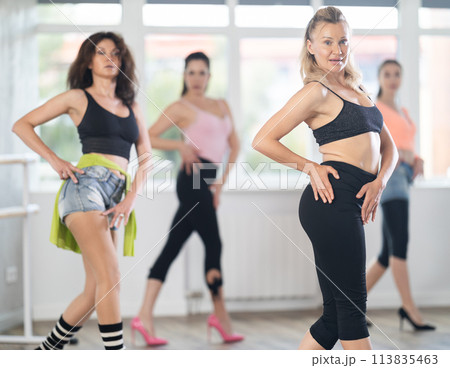 Female dancer practicing jazz-funk dance moves in high heels in studio 113835463