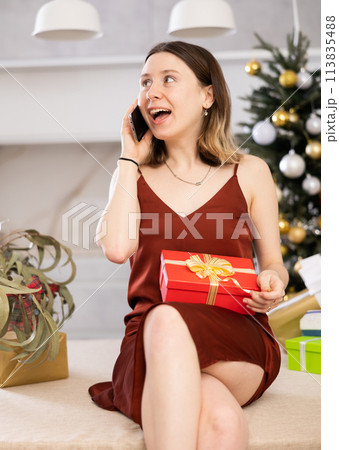 Cheerful woman is discussing something with someone on mobile 113835488