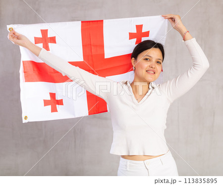 Young woman posing in studio with Georgia flag Young woman posing in studio with Georgia flag 113835895