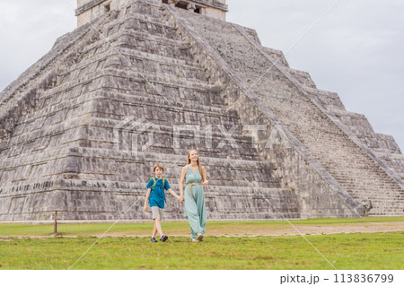Beautiful tourist woman and her son observing the old pyramid and temple of the castle of the Mayan architecture known as Chichen Itza these are the ruins of this ancient pre-columbian civilization Beautiful tourist woman and her son observing the old pyramid and temple of the castle of the Mayan architecture known as Chichen Itza these are the ruins of this ancient pre-columbian civilization 113836799