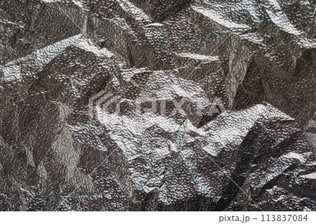 Silver crumpled foil textural background Silver crumpled foil textural background 113837084
