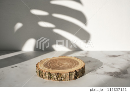 Wooden cut podium with monstera leaf shadow for natural cosmetics or products presentation Wooden cut podium with monstera leaf shadow for natural cosmetics or products presentation 113837121