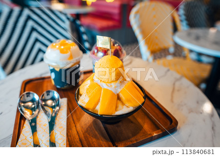 Mango ice cream in a cup at a seaside cafe Mango ice cream in a cup at a seaside cafe 113840681