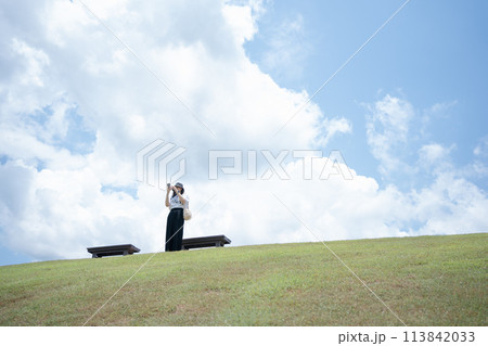 solo woman happy and enjoy with summer travel with cloudy background solo woman happy and enjoy with summer travel with cloudy background 113842033