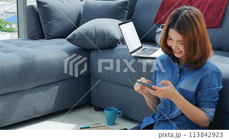 Smiling face asian woman holding smartphone with E-commerce Shopping online website Reading Online Article, Blog, vlog. Young Woman hands holding phone technology lifestyle. Woman using smart phone. Smiling face asian woman holding smartphone with E-commerce Shopping online website Reading Online Article, Blog, vlog. Young Woman hands holding phone technology lifestyle. Woman using smart phone. 113842923
