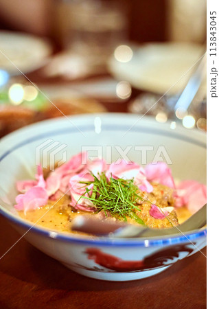 Red curry with grilled pork collar and damask rose Red curry with grilled pork collar and damask rose 113843045