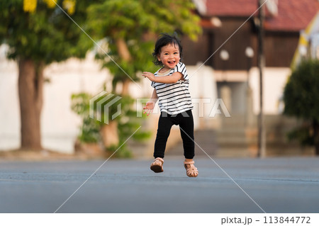 happy toddler girl running in park 113844772