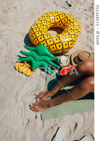 Sunbathe at the beach Women's feet, sandals and fruit Sunbathe at the beach Women's feet, sandals and fruit 113845332