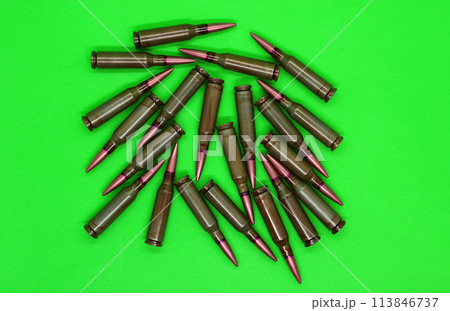 Bullets scattered on a green chroma key top view  113846737