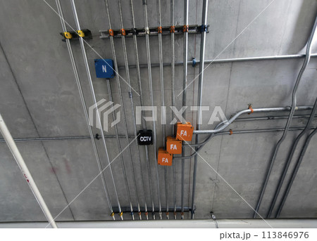 Installation metal power pipe of electrical wiring on the ceiling.Electrical cable system installation. Installation metal power pipe of electrical wiring on the ceiling.Electrical cable system installation. 113846976