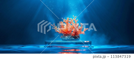 Brilliant orange coral bio-luminescence presented on a sleek platform against a deep blue ocean backdrop 113847319