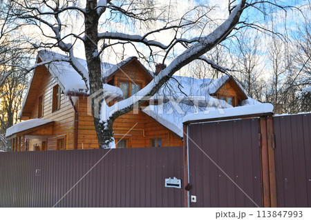 Wooden house in the snow behind a fence, Russia Wooden house in the snow behind a fence, Russia 113847993