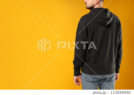 A guy in a black hooded sweatshirt A guy in a black hooded sweatshirt 113849490
