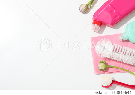 Detergents with rag and flowers on white.background Detergents with rag and flowers on white.background 113849644
