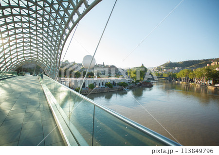Futuristic bridge of peace in Tbilisi with no people on the background of blue day sky Futuristic bridge of peace in Tbilisi with no people on the background of blue day sky 113849796
