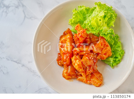 Chinese food, stir-fry Pork tenderloin with sour and sweet sauce. Food dish on white marble table with natural light, view from above with space. Chinese food, stir-fry Pork tenderloin with sour and sweet sauce. Food dish on white marble table with natural light, view from above with space. 113850174