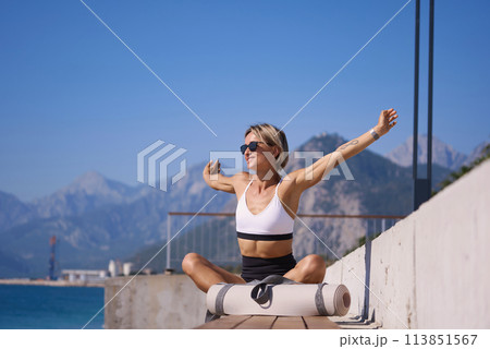 Portrait of caucasian young woman in sporty outfit relaxing meditating feeling zen-like on fitness Portrait of caucasian young woman in sporty outfit relaxing meditating feeling zen-like on fitness 113851567