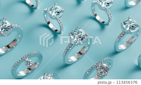 エメラルドグリーンの背景へダイヤモンドリングが均一にならびパターンの様になっている 113856376