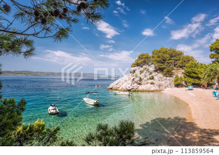 Amazing Punta Rata beach with boats against azure sea in Brela, Makarska, Dalmatia, Croatian azure coast Amazing Punta Rata beach with boats against azure sea in Brela, Makarska, Dalmatia, Croatian azure coast 113859564