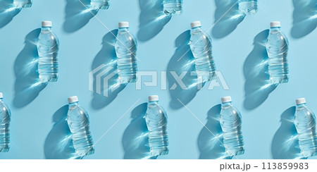 Plastic water bottle pattern on blue background. Healthy lifestyle. Pollution, environmental protection concept. Global water crisis. Minimal wide banner. Plastics garbage problem, recycling. Top view Plastic water bottle pattern on blue background. Healthy lifestyle. Pollution, environmental protection concept. Global water crisis. Minimal wide banner. Plastics garbage problem, recycling. Top view 113859983