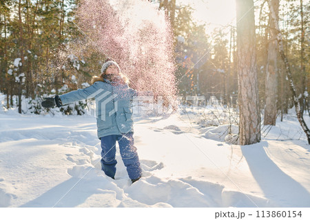 Excited boy throwing snow over his head Excited boy throwing snow over his head 113860154