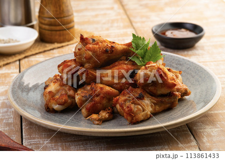 Air Fryer drummet chicken wing with garlic and pepper in a plate.Healthy oilless cooking menu. Air Fryer drummet chicken wing with garlic and pepper in a plate.Healthy oilless cooking menu. 113861433