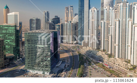 Modern residential and office complex with many towers aerial timelapse at Business Bay, Dubai, UAE. 113861624