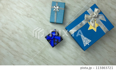 Blue gift boxes on white table, packaging for little surprise for the holiday Blue gift boxes on white table, packaging for little surprise for the holiday 113863721