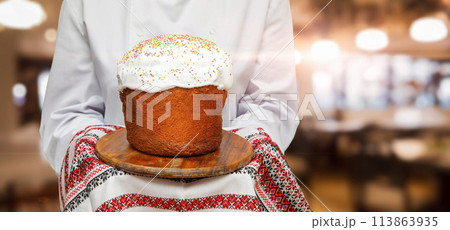 Cook shows Easter cake on towel with embroidery. Cook shows Easter cake on towel with embroidery. 113863935