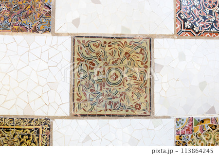 Colorful mosaic tiles at Guell Park. Broken tiles mosaic pattern. UNESCO World Heritage Site, Barcelona, Spain Colorful mosaic tiles at Guell Park. Broken tiles mosaic pattern. UNESCO World Heritage Site, Barcelona, Spain 113864245
