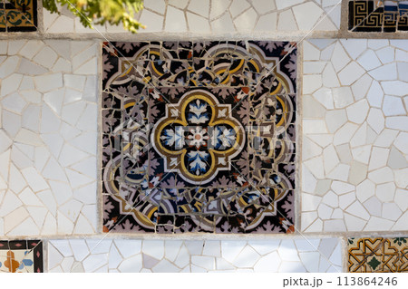 Colorful mosaic tiles at Guell Park. Broken tiles mosaic pattern. UNESCO World Heritage Site, Barcelona, Spain Colorful mosaic tiles at Guell Park. Broken tiles mosaic pattern. UNESCO World Heritage Site, Barcelona, Spain 113864246