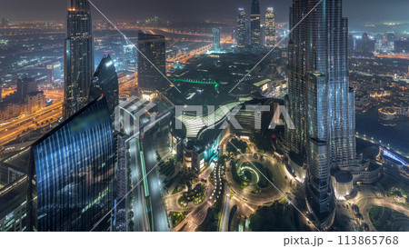 Panoramic skyline view of Dubai downtown with mall, fountains and Burj Khalifa aerial night to day timelapse 113865768