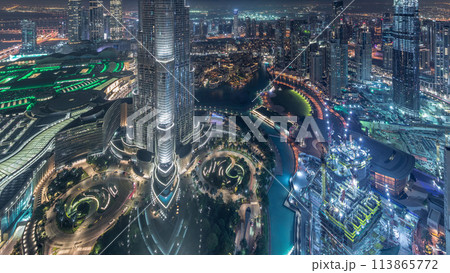 Panoramic skyline view of Dubai downtown with mall, fountains and Burj Khalifa aerial night timelapse 113865772