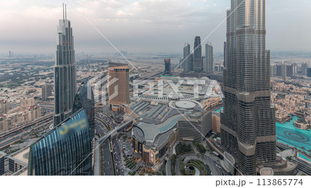 Panoramic skyline view of Dubai downtown with mall, fountains and Burj Khalifa aerial day to night timelapse 113865774