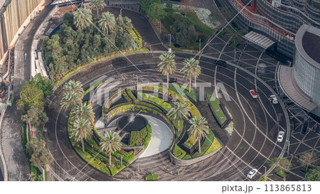 Dubai downtown timelapse with fountain with traffic on circle near entrance to tallest skyscraper 113865813