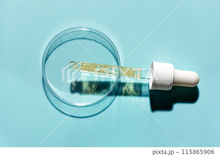 Petri dish with pipette and retinol serum sample Petri dish with pipette and retinol serum sample 113865906