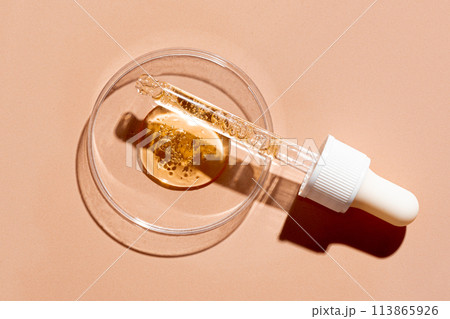 Dropper pipette and petri dish with oil gel drops Dropper pipette and petri dish with oil gel drops 113865926