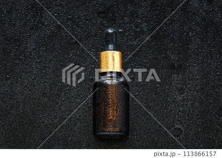 Serum dropper on wet stone background 113866157
