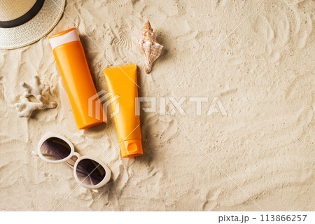 Sunscreen sunblock lotion on sandy beach Sunscreen sunblock lotion on sandy beach 113866257