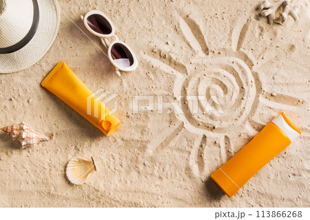 Sunblock, sunglasses and hat on summer sandy beach Sunblock, sunglasses and hat on summer sandy beach 113866268