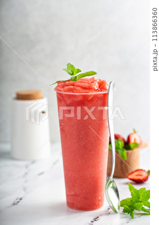 Strawberry watermelon smoothie or slushie in a tall cup Strawberry watermelon smoothie or slushie in a tall cup 113866360