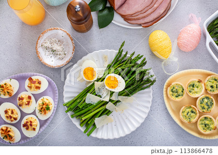 Cooked asparagus served with shaved parmesan and eggs for Easter brunch 113866478