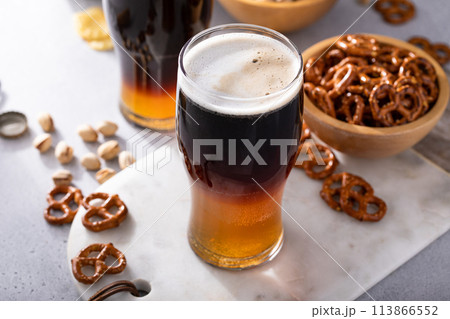 Black and tan cocktail with pale ale and dark stout beer, traditional stout cocktail 113866552