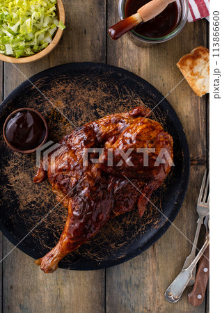Half of smoked chicken with barbecue sauce served with salad and sauce Half of smoked chicken with barbecue sauce served with salad and sauce 113866600