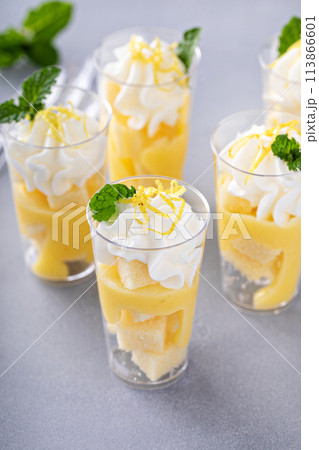 Lemon meringue parfaits in cups with pound cake and whipped cream 113866601