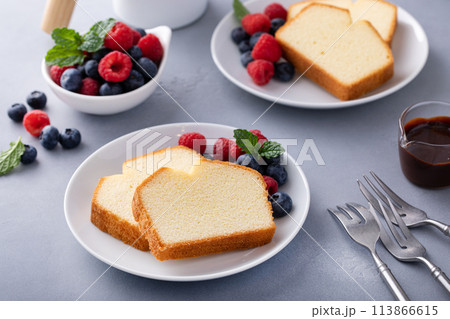 Traditional pound cake sliced on a plate served with berries Traditional pound cake sliced on a plate served with berries 113866615