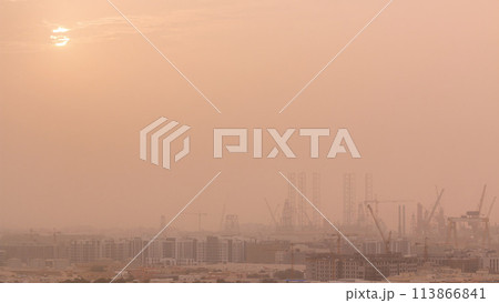 Sunset during sand storm over industry port in Dubai timelapse. Sunset during sand storm over industry port in Dubai timelapse. 113866841