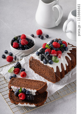 Chocolate cake with cream cheese frosting and fresh berries Chocolate cake with cream cheese frosting and fresh berries 113866881